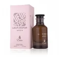 Brown perfume bottle and pink packaging with 'Lueur d'Espoir' branding on a white background
