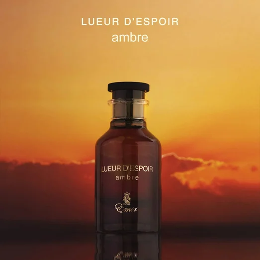 Bottle of Lueur d'Espoir Ambre perfume with a sunset background