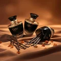 Carino Black by Rue Broca perfume bottle with vanilla pods amber glow women scent