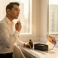 Malay man in white shirt using Rue Broca Exotic Heritage perfume on marble men scent