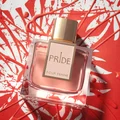 Perfume bottle labeled 'Pride Pour Femme' on a red and white abstract background
