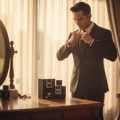 Rue Broca Pride Pour Homme EDP bottle and box on dresser Malay man adjusting tie morning light men fragrance