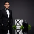 Malay man holding Rue Broca Touche Pour Homme perfume bottle and box mint leaves luxury men fragrance Malaysia