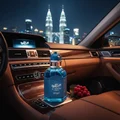 Unisex perfume bottle on car console city skyline night amber lights – Al Barari Coral