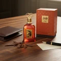 Al Fouz by Zimaya perfume bottle on wooden desk with oud chips and leather wallet luxury scent