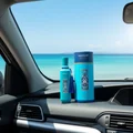 Andalusi Blue by Zimaya perfume bottle on car dashboard with sea view and blue sky fresh men fragrance
