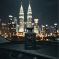 Cult by Zimaya perfume bottle on car dashboard with KL skyline lights modern men scent