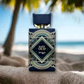 Perfume bottle labeled 'Happy Oud' by Zimaya on a beach with blurred background