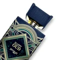 Perfume bottle with decorative navy blue and gold packaging featuring 'Happy Oud' branding