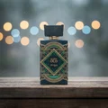 Happy Oud by Zimaya perfume bottle with rain droplets and mist unisex scent