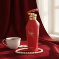 Hawwa Red by Zimaya perfume bottle on velvet cloth with coffee cup and pearls morning light