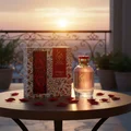 Hayam by Zimaya perfume bottle on balcony with rose petals and gold sunset romantic women fragrance