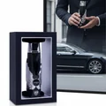 Itqan Noir by Zimaya perfume bottle in man's hand wearing suit with luxury car reflection