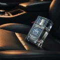 Mazaaj Infused by Zimaya perfume bottle on black leather car seat amber light luxury men scent