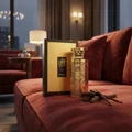 Men's luxury fragrance bottle on velvet sofa penthouse with vanilla tonka beans