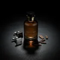 Night Shadow by Zimaya perfume bottle on black leather table with cufflinks and oud chips luxury scent