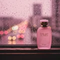 Only You by Zimaya Perfume Elixir bottle on window ledge with raindrops pink city lights