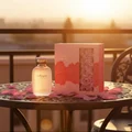 Only You by Zimaya Perfume Elixir bottle on balcony table with rose petals at sunset romantic women fragrance