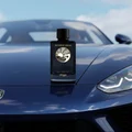 Reverie Aqua by Zimaya perfume bottle on car hood reflecting blue sky clouds luxury men fragrance