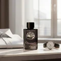 Reverie Aqua by Zimaya perfume bottle beside white shirt and watch morning light luxury men scent