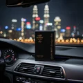 Sharaf The Club by Zimaya perfume bottle on car dashboard with city lights prestige men perfume