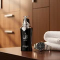 Taraf Black by Zimaya perfume bottle beside watch in locker room masculine lifestyle scent