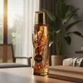 Zimaya Itqan Gold unisex perfume – Decorative bottle with a vanilla bean on a table in a room with plants and furniture