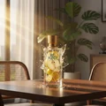 Zimaya Reflect Perfume bottle with lemon design on a table in a room with plants and curtains