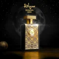 Perfume bottle with gold and black design on a dark background