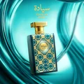 Perfume bottle with gold and blue design on a teal background